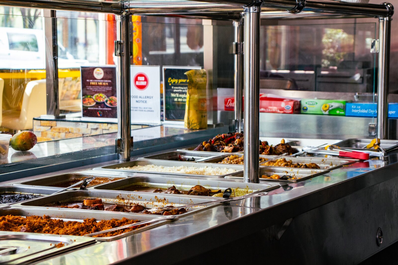 Hot, freshly prepared dishes ready to serve at Teranga Grill
