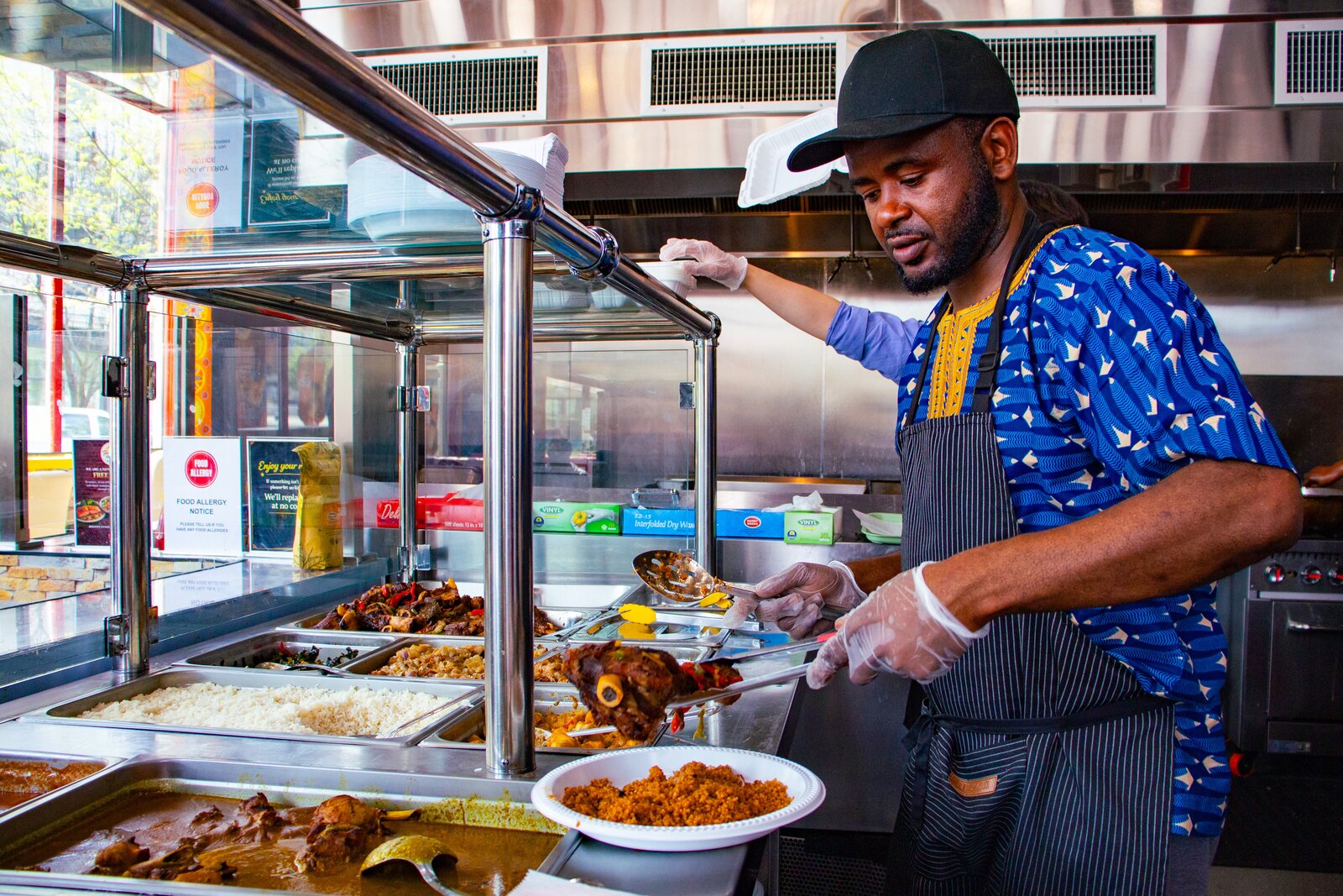 Meals being prepared and plated at Teranga Grill
